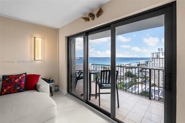 a bedroom with a bed and glass door