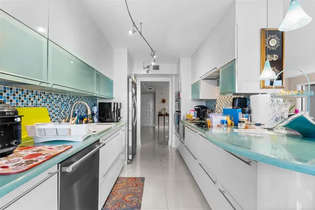 a kitchen that has a lot of cabinets and refrigerator
