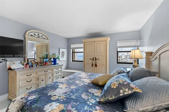 a bedroom with a bed and a flat screen television