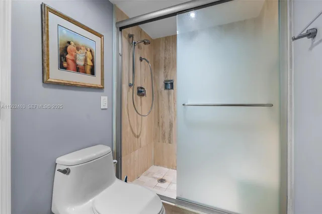 a bathroom with a toilet and a shower