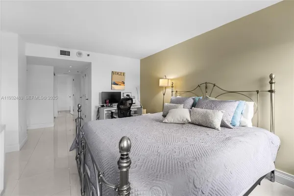 a bedroom with a bed and a couch