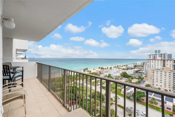 a view of a balcony with an outdoor seating