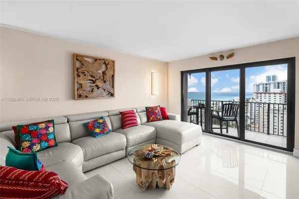 a living room with furniture and a large window with garden view