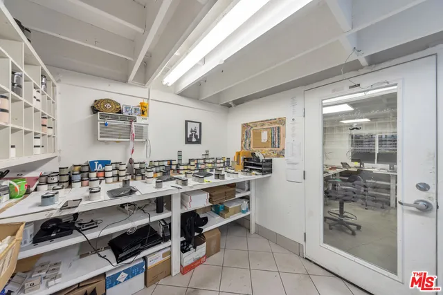 a view of a hallway with workspace and a window