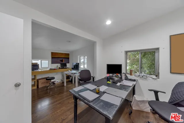 a view of a workspace with furniture and a window