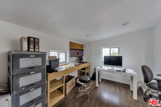 a view of a workspace with furniture and a flat screen tv