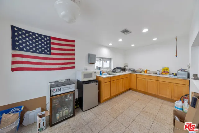 a kitchen with stainless steel appliances granite countertop a sink and cabinets