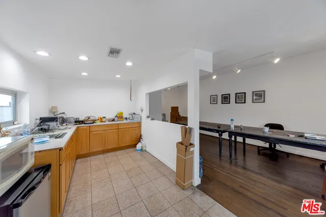 a large kitchen with a table and chairs