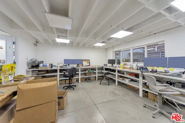 a living room with lots of furniture and clutter