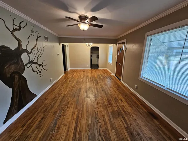 a view of a room with wooden floor and windows