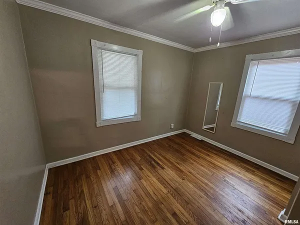 a view of a room with wooden floor and window
