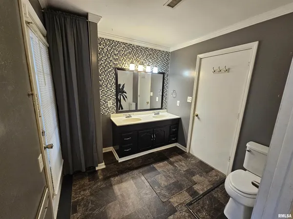 a bathroom with a sink a toilet and a mirror