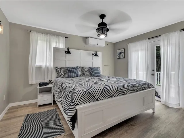 a bedroom with a bed and wooden floor