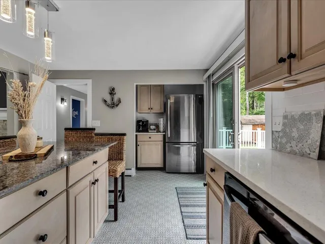 a kitchen with a refrigerator a stove a sink and a counter space