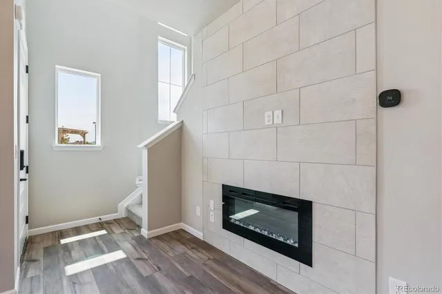 a room with a fireplace and a rug