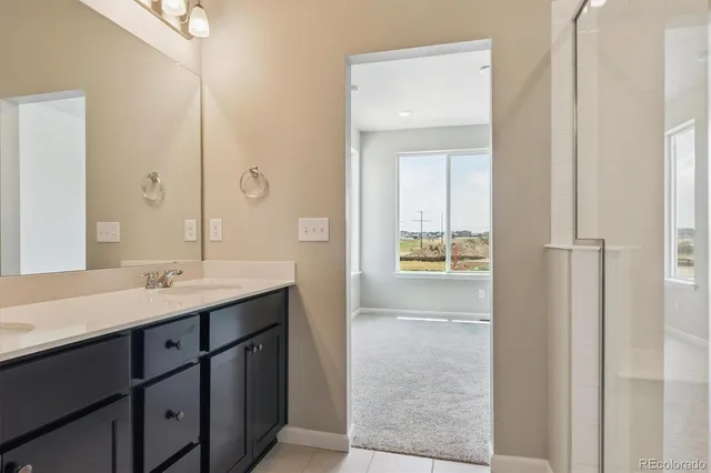 a bathroom with a sink a light fixture a vanity and a mirror
