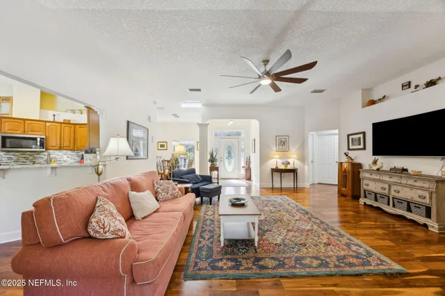 a living room with furniture a rug and a flat screen tv