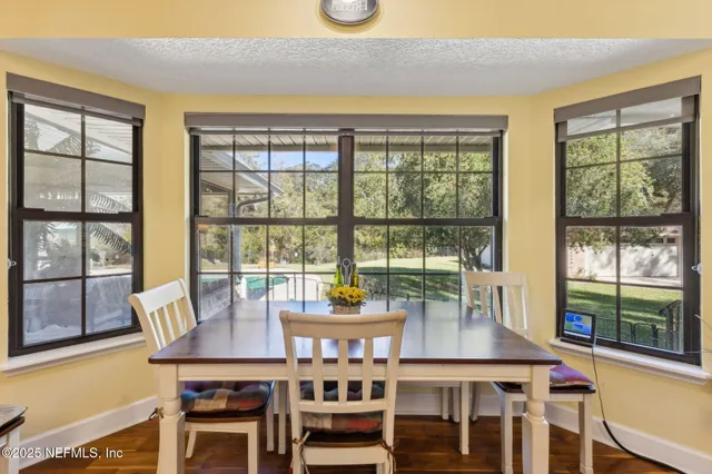 a view of a large pool with an outdoor space and seating area