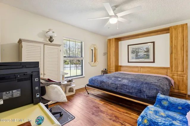 a view of a large house with a big yard and large trees
