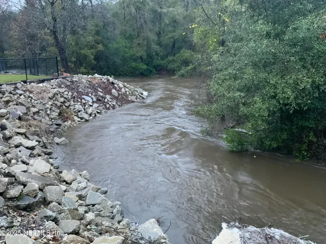 a view of grassy field with benches