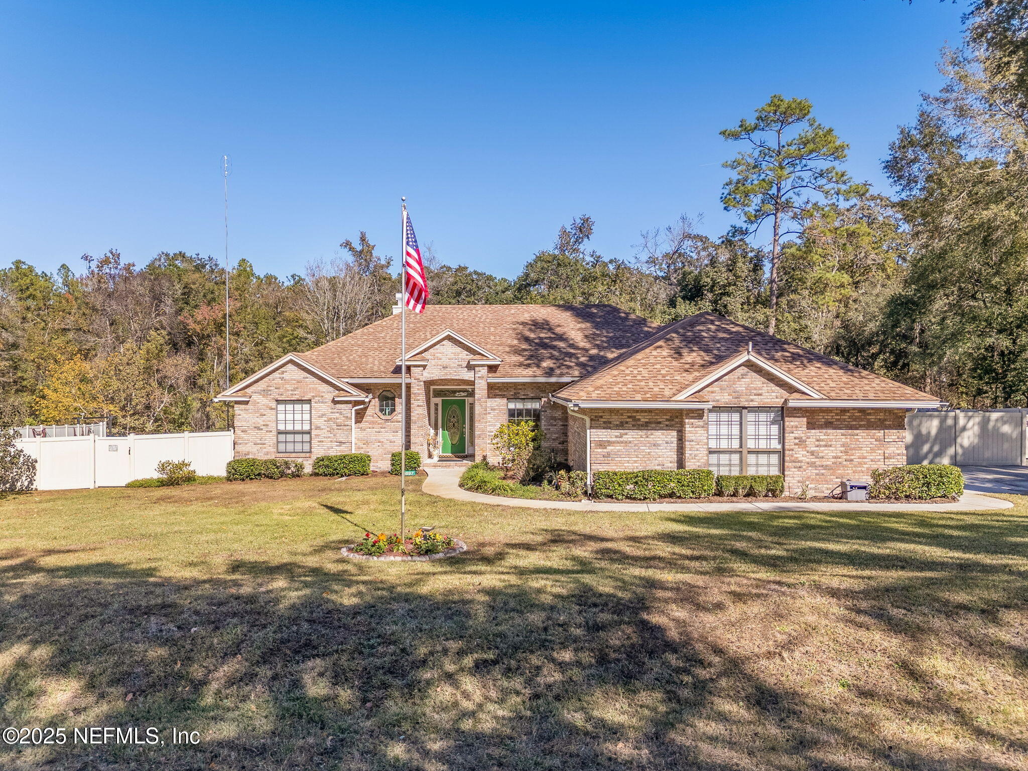 6897 Miltondale Road Macclenny, FL 32063 - Photo 47 of 58 a front view of a house with a garden and yard