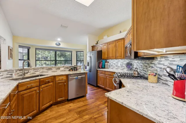 a view of a livingroom with furniture and a large window