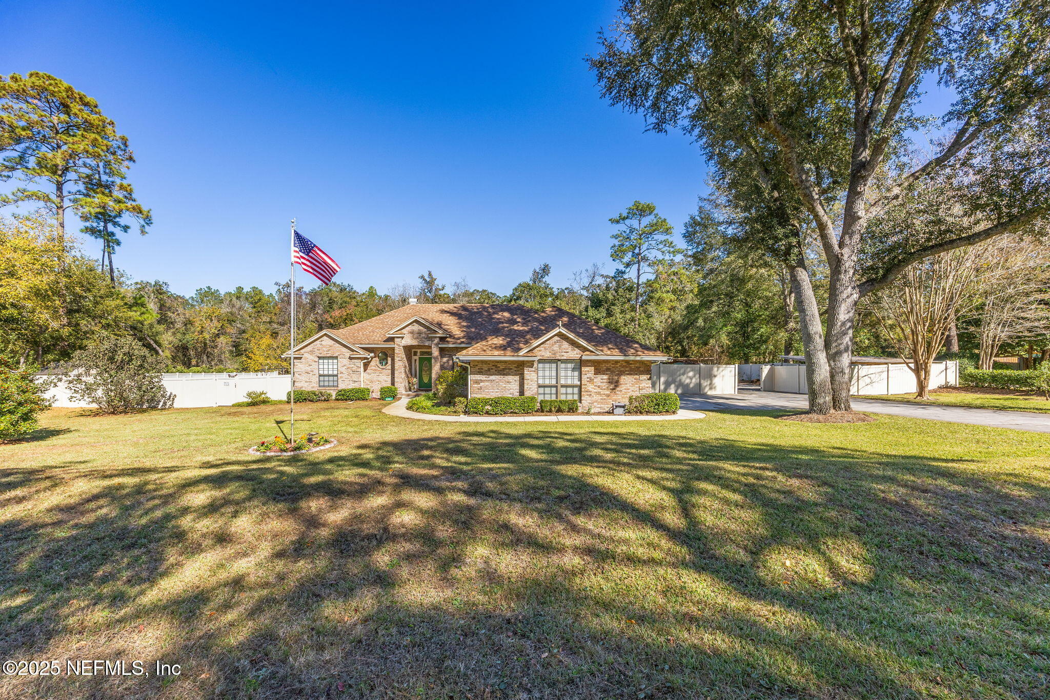 6897 Miltondale Road Macclenny, FL 32063 - Photo 57 of 58 a view of a large house with a big yard and large trees