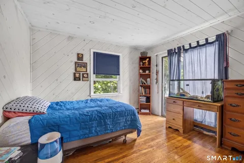 a bedroom with a bed and a dresser in it