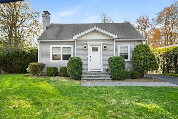 a view of a house with a yard and plants