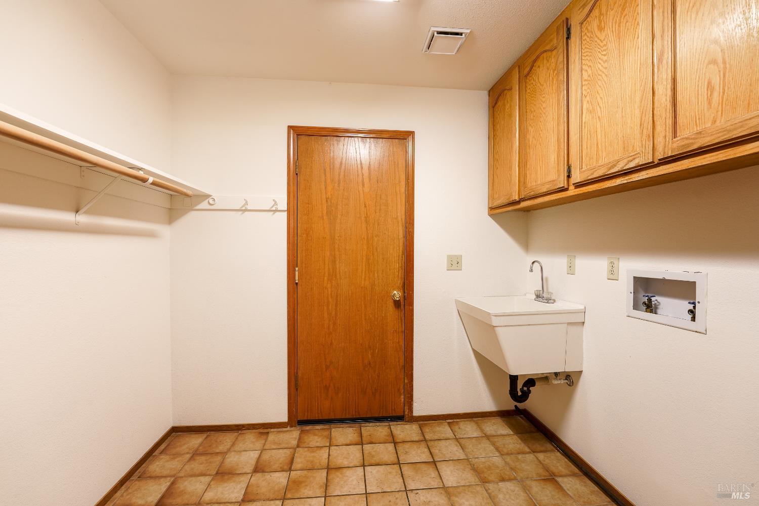 301 Toyon Road Ukiah, CA 95482 - Photo 13 of 40 Convenient laundry room with sink and cabinet storage