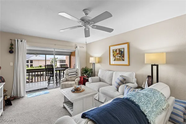 a living room with furniture and a lamp