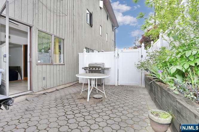 290 Hamilton Place, Unit 4 Hackensack, NJ 07601 - Photo 44 of 50 a backyard of a house with table and chairs