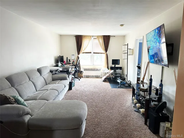 a living room with furniture a lamp and a flat screen tv