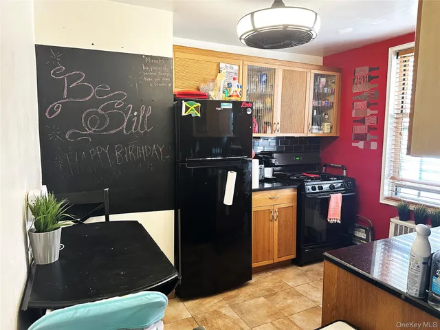 a kitchen with stainless steel appliances kitchen island granite countertop a refrigerator a stove and a sink