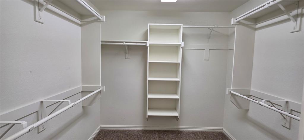 2697 Lake Ridge Drive Little Elm, TX 75068 - Photo 12 of 18 a view of walk in closet with empty racks