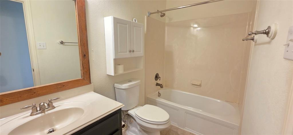 2697 Lake Ridge Drive Little Elm, TX 75068 - Photo 15 of 18 a bathroom with a sink a toilet and shower