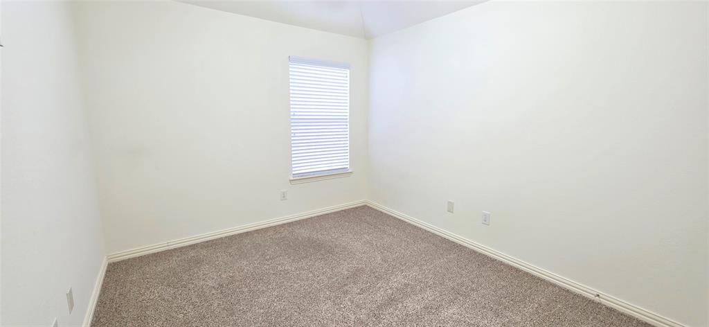 2697 Lake Ridge Drive Little Elm, TX 75068 - Photo 17 of 18 a view of an empty room with a window
