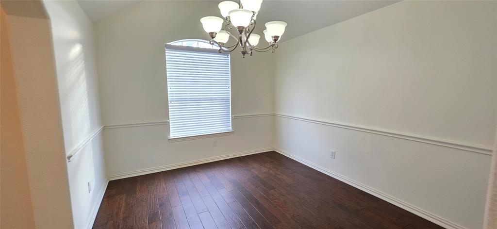 2697 Lake Ridge Drive Little Elm, TX 75068 - Photo 3 of 18 a view of a room with wooden floor and chandelier