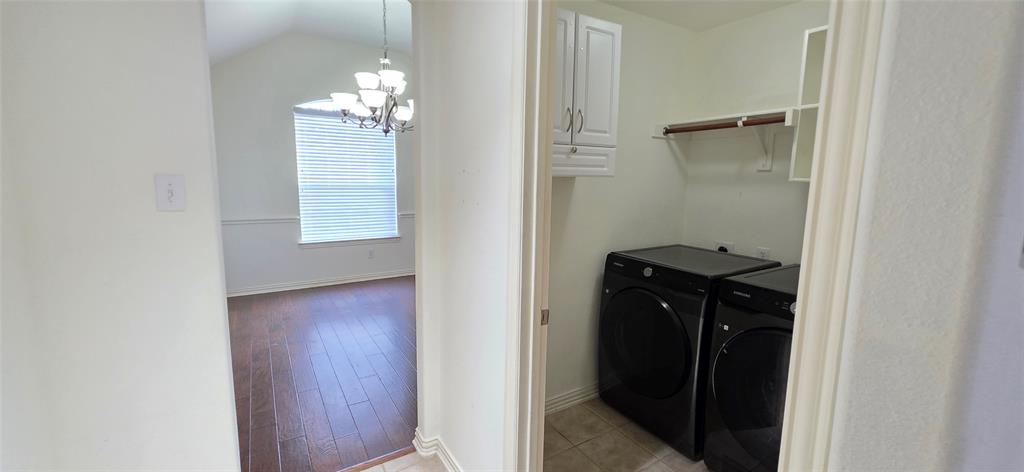 2697 Lake Ridge Drive Little Elm, TX 75068 - Photo 4 of 18 a bathroom with a light fixture a mirror and a window