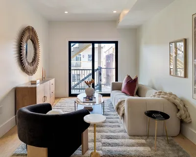a living room with furniture and a wooden floor