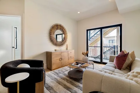 a room with a wooden floor and cabinets