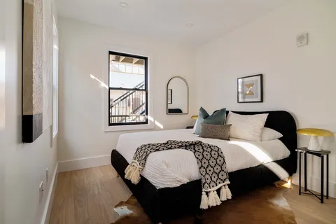 a bedroom with a bed and a window