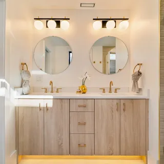 a bathroom with a sink a mirror a glass door shower and vanity