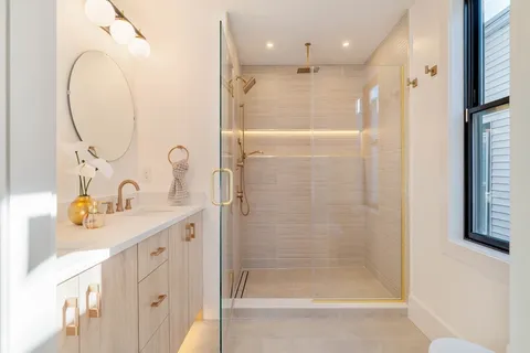 a bathroom with a double vanity sink and a mirror