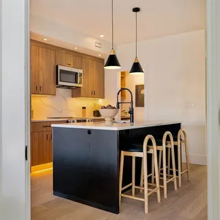 a kitchen with granite countertop a sink and cabinets