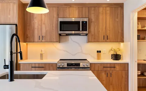 a kitchen with sink stove and refrigerator