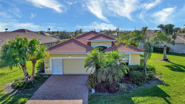 a front view of a house with a yard and a garage