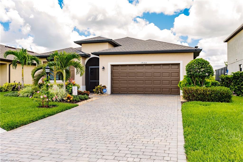 14360 Vindel Circle Fort Myers, FL 33905 - Photo 1 of 41 a front view of a house with a yard and garage
