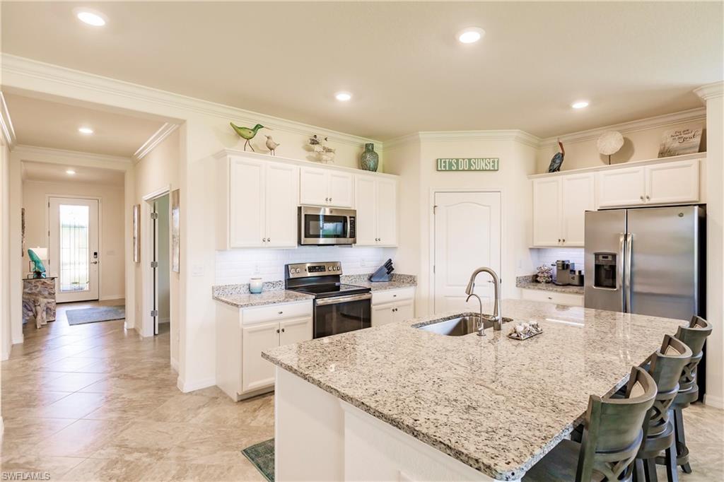 14360 Vindel Circle Fort Myers, FL 33905 - Photo 5 of 41 a kitchen with stainless steel appliances granite countertop a sink stove and refrigerator