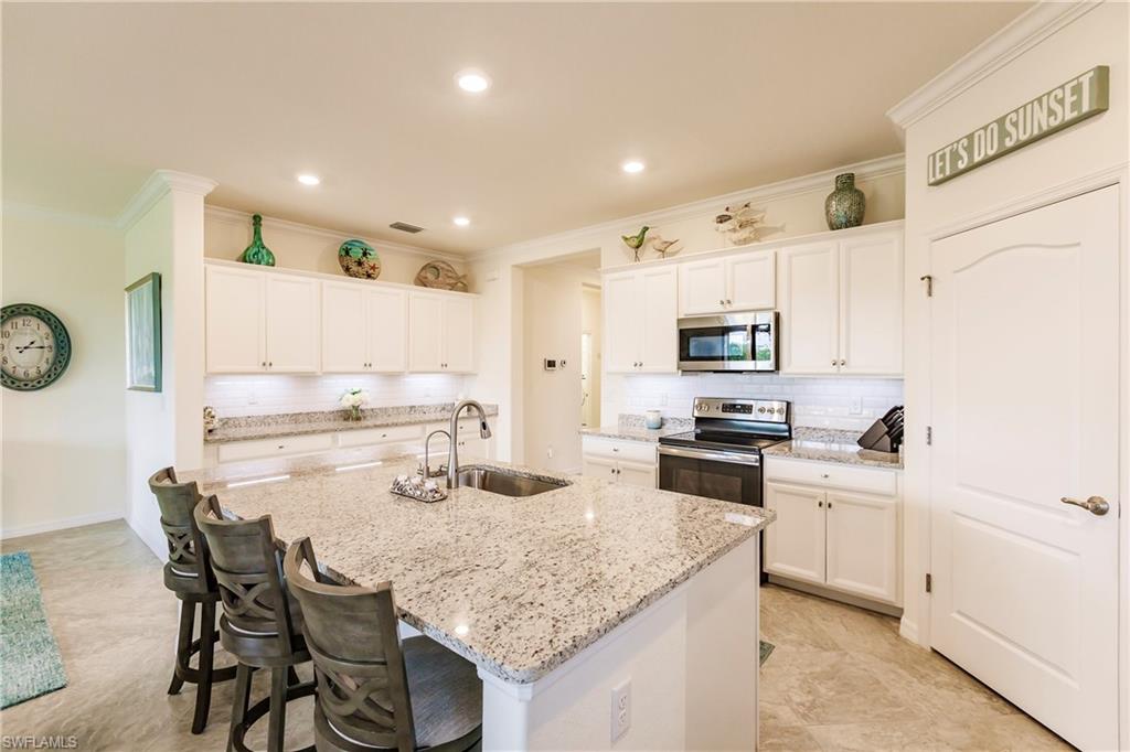 14360 Vindel Circle Fort Myers, FL 33905 - Photo 6 of 41 a kitchen with stainless steel appliances granite countertop a kitchen island and chairs in it
